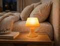 Mini desk lamp glowing on nightstand